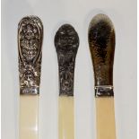 An ivory page turner with hammer textured handle,