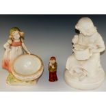 A Continental pottery figure of a young girl behind a basket,