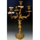 An 18th Century ormolu three branch candelabrum of Rococo form the column supporting a collar with