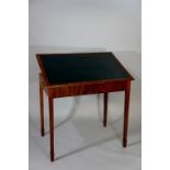 A George III mahogany table the rectangular top inset with a tooled blue leather writing surface