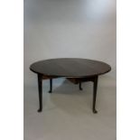 A George III mahogany oval drop leaf table on turned legs with pad feet, 134cm wide,