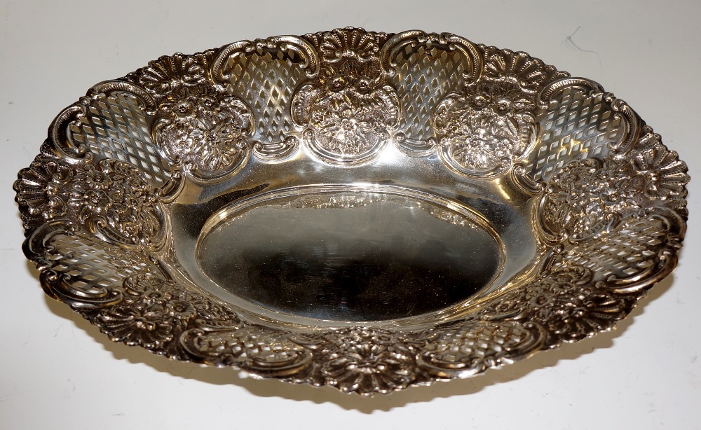 A Victorian shaped oval dish embossed with alternate panels of flower heads and shells,