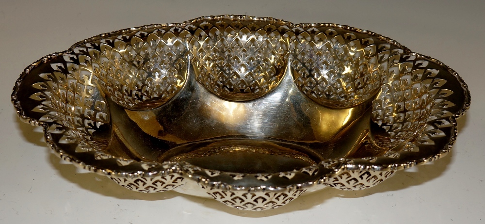 A shaped oval dish with scroll cast border,