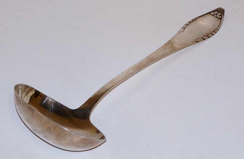 A Danish silver ladle with leaf clasped hammer textured handle and plain bowl, 31.