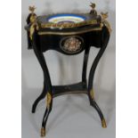 A Napoleon III ebonised two tier planter of serpentine shape the  lift out top with circular