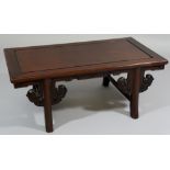 A Chinese hardwood low table the rectangular top above shaped frieze and splayed legs with flat