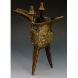 A bronze Jué of conventional form cast with a band of mythical motifs beneath lappet border,