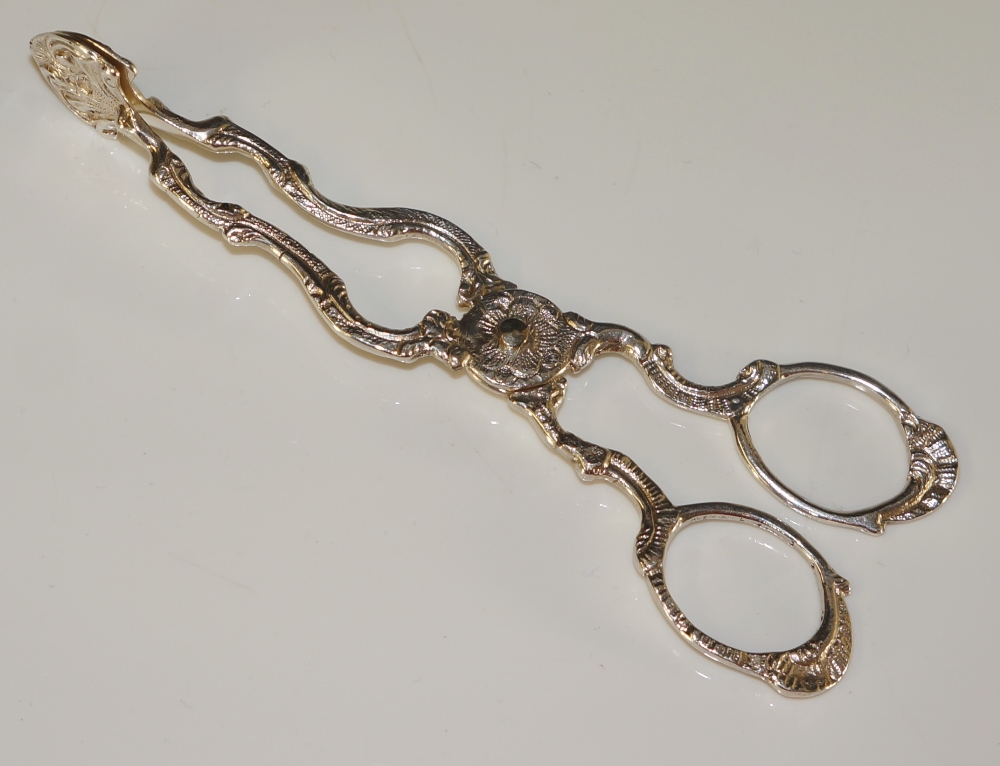 A pair of Victorian scissor action sugar nips in George III style with cast handles, 12cm long,