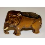 A Victorian brass elephant nib cleaner with carved ivory tusks, faded blue velvet cushion, 4cm high,