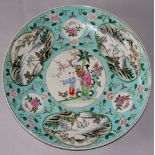 A large Chinese Famille Rose charger painted to the centre with a female and child beneath prunus