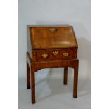 A walnut bureau in George I style outlined throughout with parquetry stringing,