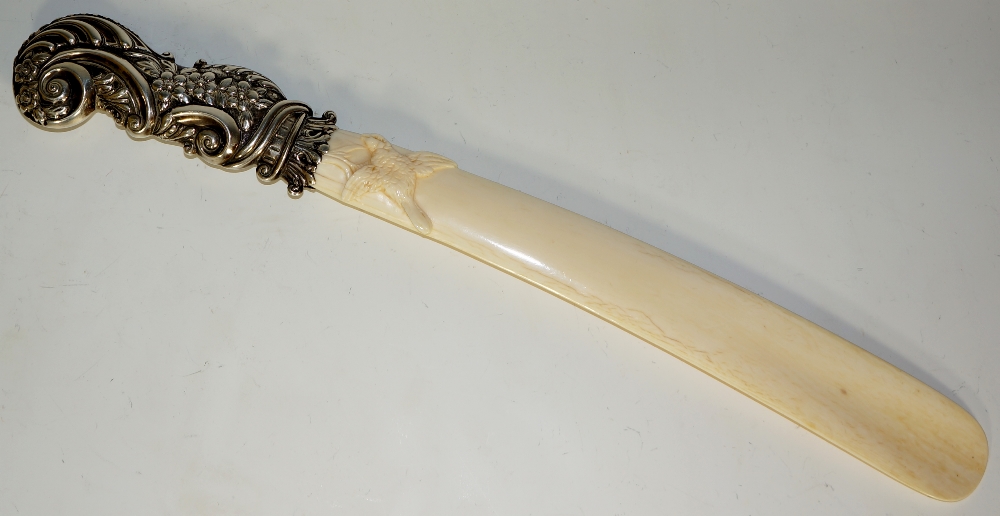 A Victorian silver mounted ivory page turner the tapered blade finely carved with a finch the