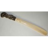 A Victorian silver mounted ivory page turner the tapered blade finely carved with a finch the