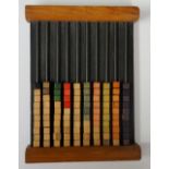 A wooden abacus with cuboid wooden beads strung on metal rails,