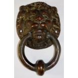 A bronze door knocker modelled as a lion mask with ring handle, 16cm high overall,