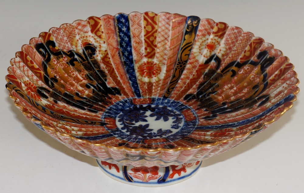 A Japanese Imari porcelain fluted circular bowl decorated overall in typical palette with fan