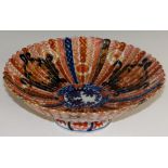 A Japanese Imari porcelain fluted circular bowl decorated overall in typical palette with fan