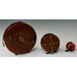A large mahogany and brass fishing reel with pair of turned wood brass handles,