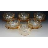 A 19th Century set of six iridescent amber coloured glass finger bowls with five matching stands,