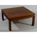 A Chinese hardwood coffee table the square top above a shaped frieze and square legs terminating in