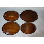 Four mahogany oval trays, all galleried, two handled, some with inlaid borders and centres,