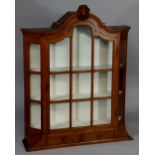 A Dutch oak display cabinet with arched top centred on a feather and scroll crest,