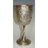 A Chinese silver coloured metal pedestal goblet the urnular shaped body embossed and repoussé