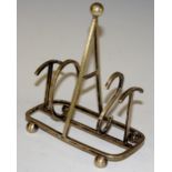 An EPNS toast rack the frame as the word "TOAST", sphere feet, 12.5cm wide, 13.