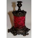 A Victorian cranberry glass and brass "Go-to-bed", foliate detailed,