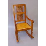 Robert Thompson of Kilburn - an English oak rocking chair the rectangular back with pair of woven