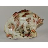 An 18th Century porcelain model of a recumbent Florentine boar, decorated in brown,