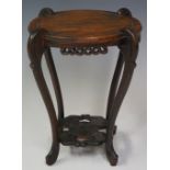 A Chinese hardwood two tier stand the circular dished top on four scrolling legs joined by a