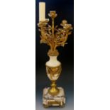 A French gilt metal mounted marble urnular shaped four branch candelabrum the top with leaf and