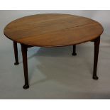 A George III mahogany oval drop leaf table on turned legs with pad feet, 132cm wide,