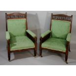 A pair of late Victorian rosewood library chairs the arched backs above geometric and plain spindle