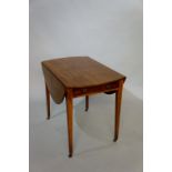 A George III mahogany oval Pembroke table the oval top above frieze drawer on square tapered legs