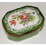 A 19th Century enamel pill box the hinged cover painted with a floral spray within a white enamel