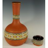 Christopher Dresser (after) - a Watcombe pottery terracotta bottle shaped vase,