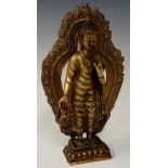 A gilt bronze model of a deity standing before a detachable cast niche,