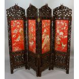 A fine Chinese hardwood four-fold screen the frame carved overall with fruiting vine,