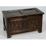 A small late 17th Century oak coffer the two panel lid above a plain frieze and two panel front