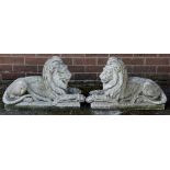 A pair of reconstituted recumbent lions, rectangular bases, 66cm wide, 41cm high,