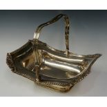 A rectangular basket with swing handle, the gadrooned border with acorn and leaf clasped corners,