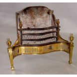 A George III style iron and brass serpentine-shaped fire grate the back with swept sides and