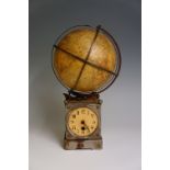A German mechanical globe clock the 18cm papered globe turning on a series of gears in conjunction