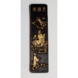 A Chinese ink block the front relief moulded and detailed in gilt with a Taoist sage and figures,