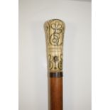 An 18th Century ivory handled piqué inlaid walking stick with stylised scrolling foliate decoration,