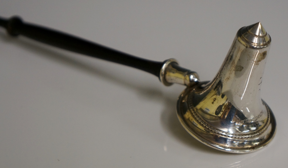 A silver candle snuffer with turned wooden handle, conical with beaded border, 28cm long by B & Co.