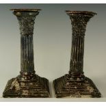 A pair of late Victorian Corinthian column stop fluted dwarf candlesticks,