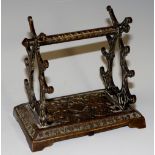 A Victorian brass plated cast iron pen rest of scrolling design, provision for seven pens,